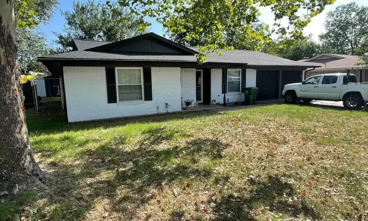 Professional roofing crew working on a residential roof in Holmen